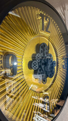 Golden mechanical clock with visible gears, showcasing precision and timeless design, ideal for themes of time management and mechanical art