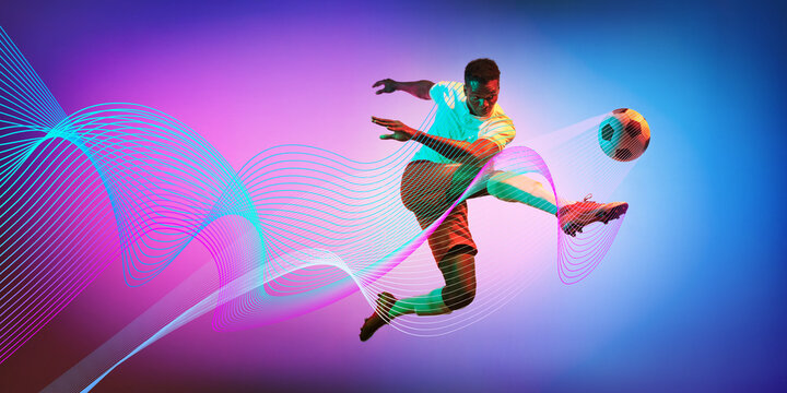Powerful kick. Man, soccer player in motion during game, kicking ball against gradient background with neon lines wave elements. Concept of sport, action, competition. Creative banner, ad. Modern art