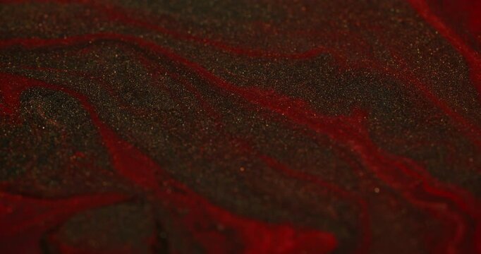 Glitter deformation. Shimmering liquid. Red gold flow with marble effect abstract chaotic structure. Shiny gray dust metal small decorative particles.