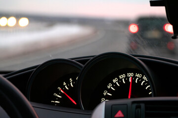 Close-Up of Car Speedometer With Blurred Road in Background. motion, speed, and travel on a...