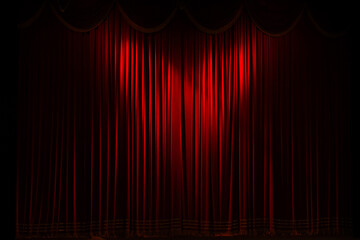 Theater stage with maroon red curtain with spotlight