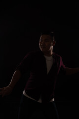 Asian man dancing to music