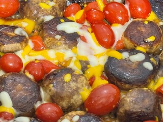 Shiraz, Iran - October 31, 2024: Roasted Mushrooms, Cherry Tomatoes, and Melted Cheese Dish