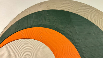 Abstract wall art featuring textured concentric circles in beige, green, and orange, perfect for modern interior decor themes and color theory studies