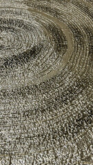 Fototapeta premium Silver textured spiral pattern on a reflective surface, suitable for modern art backgrounds, abstract designs, and decorative uses in commercial and residential spaces
