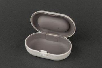 Empty Open Wireless Earbud Case on Dark Background for Product Display