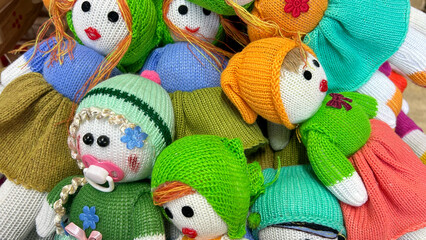 Vibrant handmade knitted dolls with colorful yarn, perfect for children's educational play and collectors