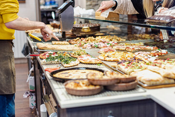 Pizza by the slice in an italian bakery.