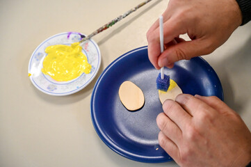 Close-up of the hands of a child with special needs while coloring and drawing. A schoolboy draws at school. Children with intellectual disabilities.