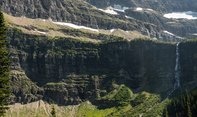 Narrow Band Of Thunderbird Falls Pours Over Cliff Below The Melting Glacier Above
