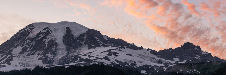 Panorama of The Top Of Mount Rainier With Orange Evening Clouds Passing Over