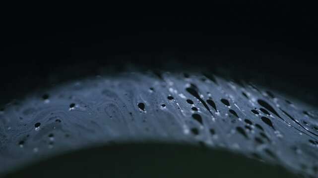 Transparent liquid. Broken hole. Set of caves in pure clear split crushed ice with cracks on modern art black darkened background.