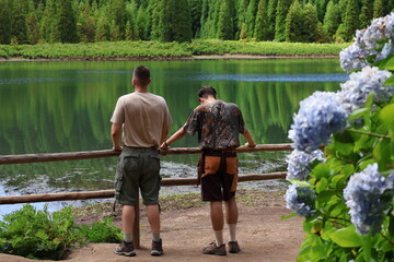 Brotherhood at the lake. Ideal landscape for adventure trips. Lagoa do Canario, Portugal, Azores...