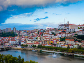 Fototapeta premium Aerial view of Coimbra city old town on the hill. Panoramic drone cityscape and Mondego River, Portugal