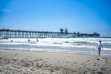 Oceanside City Beach with distant Municipal Pier and ocean waves.
