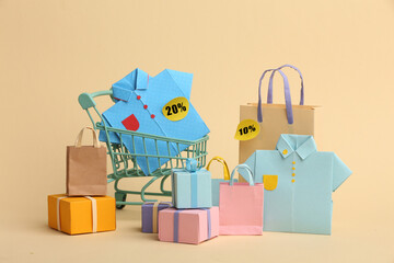 Paper crafts shopping bags shirts and gifts on color background, discount shopping and shopping concept. Black Friday