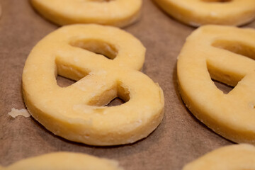 Unbaked cookie dough shaped into pretzels
