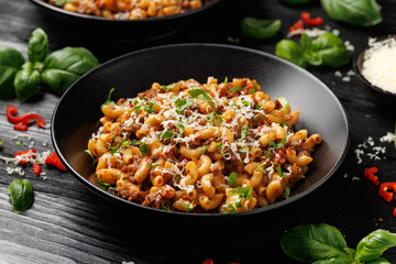 Homemade Taco Beef Pasta in a black bowl. Mexican food.