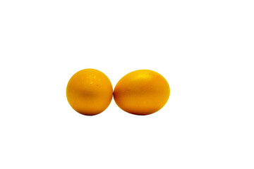 Two eggs are sitting on a white background. The eggs are yellow and appear to be shiny. The scene is simple and uncluttered, with the eggs being the main focus