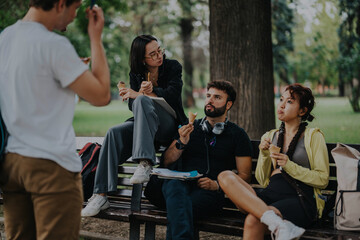 A group of students and their professor share a relaxed ice cream break in a park setting following their class, enjoying casual conversation and leisure time.