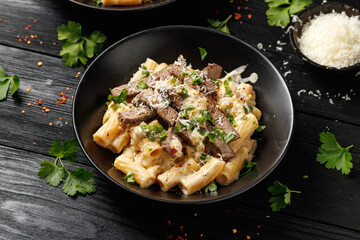 Philly cheese steak pasta in black bowl