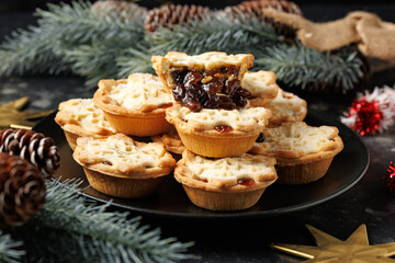 British Christmas mince pies or fruit pie British Christmas mince pies or fruit pie with decoration, gifts, green tree branch