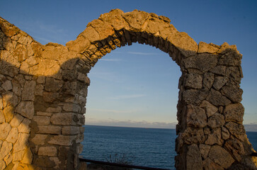 ruins of the old castle Roman arched gate, part of a fortress on a rocky seashore. Cape Kaliakra, Bulgaria