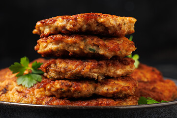 Chicken fritters or cutlets stack with cheese and herbs