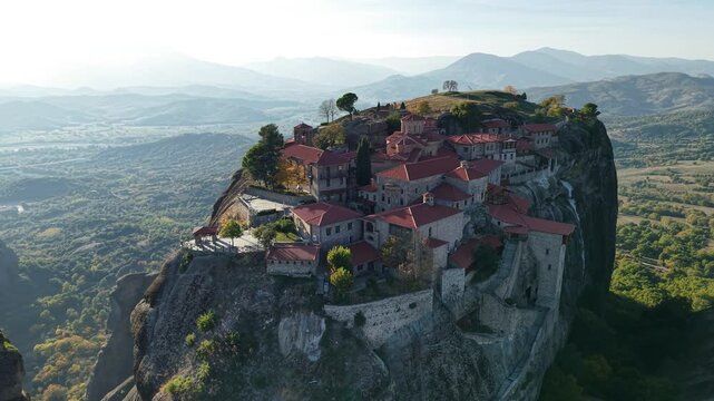  the stunning monasteries atop towering cliffs in Meteora, Greece during sunset