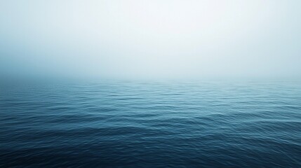 Obraz premium Calm Ocean with Misty Horizon