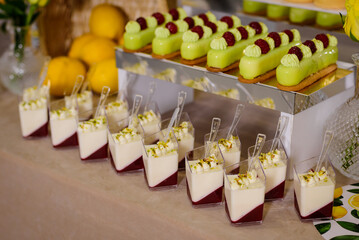 Candy bar. Table with sweets, candies, dessert. Dessert with mousse in a transparent dish.