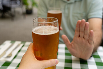 Reject a glass of beer, man refusing alcohol, stop drinking, sobriety concept, saying no to beer...