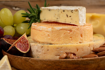 Cheese plate of color cheeses variety, yellow, white and blue cheese board, assorted dairy products