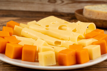 Cheese plate of color cheeses variety, yellow, white and blue cheese board, assorted dairy products