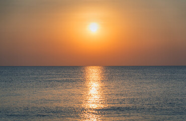 Beautiful sunset over the ocean with a soft glow and serene atmosphere