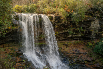 beautiful waterfall called Dry falls  North Carolina in Fall with pretty organ trees and leafs 
