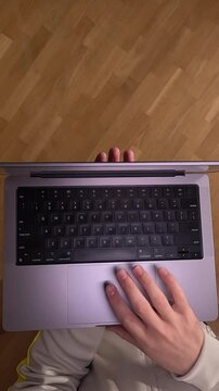 vertical video pov First person view Man opens laptop starts working on computer