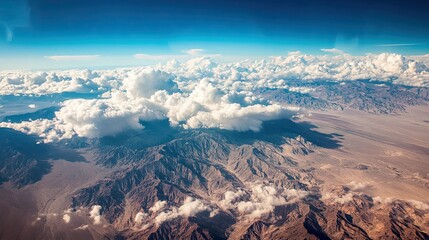 Aerial view of clouds,  mountains in the distance․