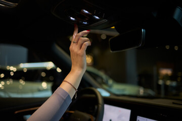 Discover a modern car interior with a stylish hand adjusting mirror for added functionality