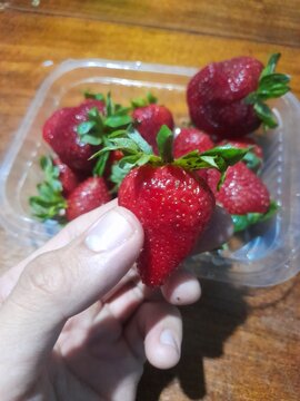 strawberry in a hand
