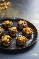 Stuffed mushroom canapes with spinach, sun dried tomatoes and cheese