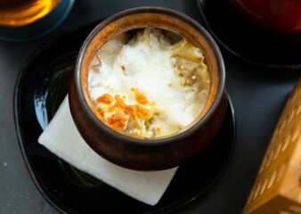 Delicious dumplings in a pot, baked with cream. Close-up image