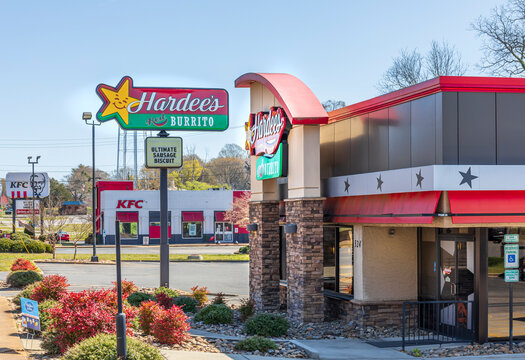 SHELBY, NC, USA-28 MARCH 2022: Hardee's fast food restaurant, Grover St.., with a KFC restaurant in background.