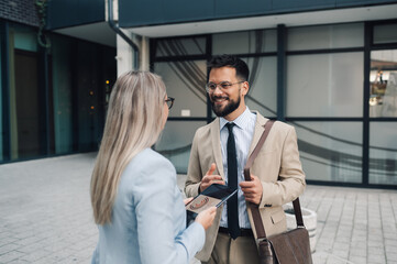 Business people having conversation about work outdoors