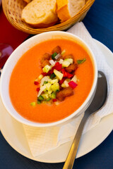 Image of spanish traditional cold soup gazpacho in bowl with tomatoes and cucumber..