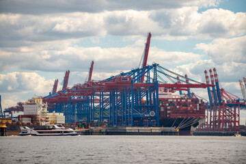 Obraz premium Container cargo ship in a commercial dock. New York container port. Ship container port. Container terminal in the port. Terminal port.