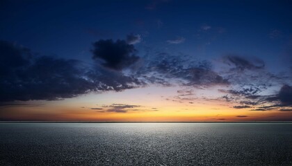 black asphalt floor background and dark blue night sky sunset horizon with subtle clouds