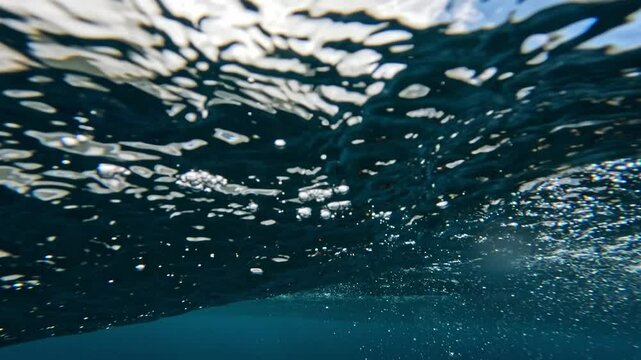Underwater view of ocean clear water. Abstract bubbles texture, pattern, slow motion 4k. 