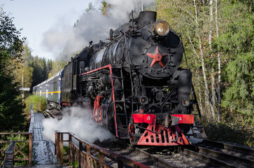 Soviet steam locomotive of the L series (L5164) with the Ruskeala express arrives at the Ruskeala Mountain Park station.