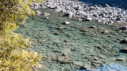 Crystal clear blue glacier water mountain river in New Zealand